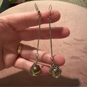 Silver toned dangling earrings with wire wrapped marbles